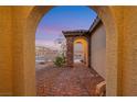 Inviting arched entry and stone accents create curb appeal at 10184 Fire Skye Ave, Las Vegas, NV 89166