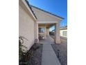 Inviting covered front entrance with desert landscaping and secure ADT home security system at 1395 Kapelle St, Henderson, NV 89052