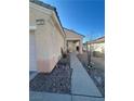 Charming home exterior featuring a covered entrance, desert landscaping and a walkway at 1395 Kapelle St, Henderson, NV 89052