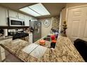 Well-lit kitchen featuring granite countertops and a functional layout for easy cooking at 1908 Tierra Vista Dr # 206, Las Vegas, NV 89128