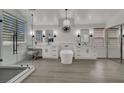 Modern bathroom with a walk-in shower, dual vanities, a standalone tub, and sleek lighting at 2008 Arbor Forest St, Las Vegas, NV 89134