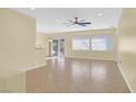 Spacious living area with a ceiling fan and sliding glass doors to the backyard at 2405 Gamma Ray Pl, Henderson, NV 89044