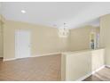 Bright, open living room featuring neutral walls and tile flooring at 2405 Gamma Ray Pl, Henderson, NV 89044