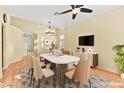 Bright dining area featuring a modern table, hardwood floors and a large picture window at 255 El Camino Verde St, Henderson, NV 89074