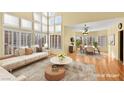 Bright living room with large windows, plantation shutters, and neutral-toned furniture at 255 El Camino Verde St, Henderson, NV 89074