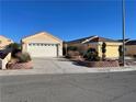 Street view of single-story house with two-car garage and desert landscaping at 2694 Hillgrass Rd, Las Vegas, NV 89123