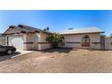 Single-story home featuring gravel landscaping, arched windows, and gated entry for added curb appeal at 2712 Rialto Rd, Las Vegas, NV 89108