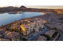 Scenic aerial view of the condo buildings set against a lake, and rugged terrain at 30 Via Mantova # 202, Henderson, NV 89011