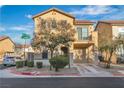 Two-story home featuring neutral siding, two-car garage, balcony, and low-maintenance landscaping at 4228 Hickman Ct, Las Vegas, NV 89129