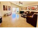 Open concept living room featuring tile floor, large sliding glass door, and recessed lighting at 4562 White Cap Mill St, Las Vegas, NV 89147