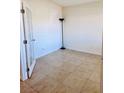 Cozy room features neutral walls, tile flooring, and a door that lets in natural light at 4562 White Cap Mill St, Las Vegas, NV 89147