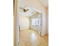 Bright room features tile flooring, neutral walls, a ceiling fan, and a window at 4562 White Cap Mill St, Las Vegas, NV 89147