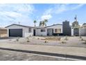 Charming single-story home featuring a freshly painted exterior, garage, and desert landscaping at 4629 Lilliput Ln, Las Vegas, NV 89102