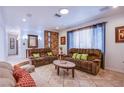 Inviting living room with tile flooring, plush sofas, and decorative wall accents at 4871 Reiter Ave, Las Vegas, NV 89108