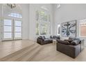 Open-concept living room with lots of natural light, high ceilings and modern decor at 5271 Villa Vecchio Ct, Las Vegas, NV 89141