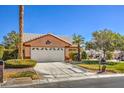 Beautiful single-Gathering house featuring a pristine lawn, mature landscaping, and a convenient two-car garage at 5452 Green Palms St, Las Vegas, NV 89130