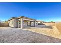 View of a newly constructed backyard with a covered patio and block wall at 567 Jerry Bird Ct, Las Vegas, NV 89123