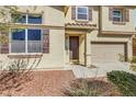 Close-up of the home's entrance, showcasing a well-kept front yard and inviting doorway at 5976 Ancona Dr, Las Vegas, NV 89141