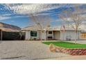 Inviting single-story house featuring low maintenance desert landscaping and covered entryway at 604 Canyon Rd, Henderson, NV 89002