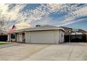 Ranch-style home with a spacious driveway, two-car garage, and desert landscape at 604 Canyon Rd, Henderson, NV 89002