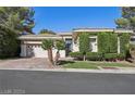 Beautiful single-story home featuring a two-car garage and manicured landscaping at 613 Pinnacle Heights Ln, Las Vegas, NV 89144