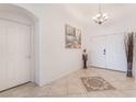 Inviting entryway featuring tile floors, neutral walls, decorative accents, and a chandelier at 6608 Ringbill Ct, North Las Vegas, NV 89084