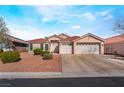 Charming single-story home featuring a well-maintained front yard, three-car garage, and tiled roof at 6608 Ringbill Ct, North Las Vegas, NV 89084