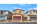 View of home featuring a two-car garage, desert landscaping, and a well-maintained front yard at 7462 Dragonfruit Ave, Las Vegas, NV 89113