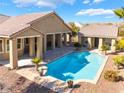 Inviting backyard pool with a covered patio area, perfect for relaxation and entertaining in a serene setting at 7860 Thunder Echo St, Las Vegas, NV 89131