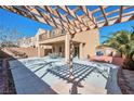 Backyard patio featuring an open air area, pergola, and a balcony above overlooking the yard at 8429 Spirit Vale Ave, Las Vegas, NV 89117