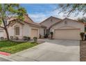 Charming single-story home featuring a well-manicured front yard, a two-car garage and a stucco exterior at 8605 Wild Diamond Ave, Las Vegas, NV 89143