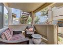 A private patio has comfy outdoor seating; stairs in the background lead to upper units at 905 Rockview Dr # 101, Las Vegas, NV 89128