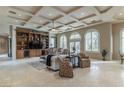 Bright living room with coffered ceilings, tile floors, and a custom built-in entertainment center at 9325 Verlaine Ct, Las Vegas, NV 89145