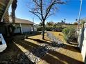 Landscaped backyard featuring decorative rocks and manicured green hedges at , Las Vegas, NV 89121