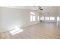 Bright and airy living room featuring wood-look tile floors, high ceilings, and abundant natural light at 1006 Blue Lantern Dr, Henderson, NV 89015