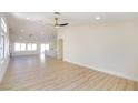 Open-concept living room with new wood-look flooring, recessed lighting, and seamless flow to the kitchen at 1006 Blue Lantern Dr, Henderson, NV 89015