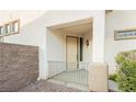 Charming front porch featuring desert style architecture and decorative iron railings at 11204 Newbury Hills Ave, Las Vegas, NV 89138