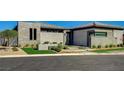 Contemporary home showcasing modern landscaping with native plants and decorative gravel at 11296 Villa Bellagio Dr, Las Vegas, NV 89141