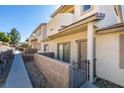 Stylish townhome featuring private patio with stone wall and well-maintained landscaping at 2050 Los Feliz St # 112, Las Vegas, NV 89156