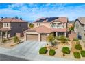 Beautiful home featuring a three-car garage, well-maintained landscaping, and eco-friendly solar panels at 2176 De Narvik Dr, Henderson, NV 89044