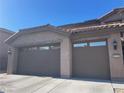 Close up of a three-car garage with a tile roof and modern design at 2176 De Narvik Dr, Henderson, NV 89044