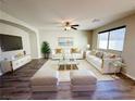 Bright living room featuring hardwood floors, white sofas, and modern decor at 2241 Chandler Ranch Pl, Laughlin, NV 89029