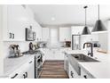 Modern kitchen featuring stainless steel appliances, shaker cabinets, and pendant lighting at 2493 Verdello St, Henderson, NV 89044