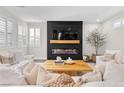 Bright living room with a modern fireplace feature and ample natural light at 2493 Verdello St, Henderson, NV 89044