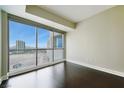 Bedroom with hardwood floors features floor to ceiling windows with city views at 2700 Las Vegas Blvd # 1604, Las Vegas, NV 89109