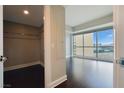 Bedroom with walk-in closet shows window with city views and hardwood floors at 2700 Las Vegas Blvd # 1604, Las Vegas, NV 89109