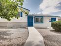 Charming single-story home with blue trim, door, and rock landscaping at 2712 Royal St, North Las Vegas, NV 89030