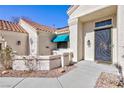 Charming front entrance featuring a decorative security door, covered entryway and desert landscaping at 3109 Bangor Ct, Las Vegas, NV 89134