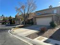 Two-story home featuring an attached two-car garage, desert landscaping, and a concrete driveway at 3177 Rabbit Creek Dr, Las Vegas, NV 89120