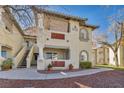 Condo building featuring private balconies, exterior staircases, and lush landscaping at 3412 Winterhaven St # 101, Las Vegas, NV 89108